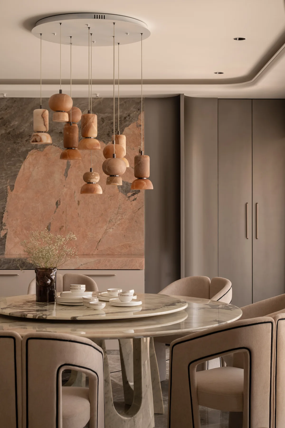 Warm stone, sculptural lighting and considered details at Nilaya, a residence by DG Studio Architects